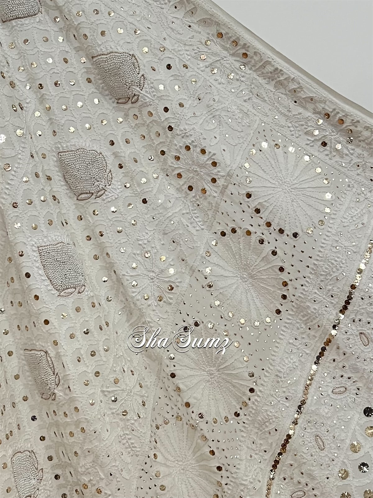 Lily white saree featuring intricate Chikankari embroidery, elegant Mukaish work, and shimmering pearls.
