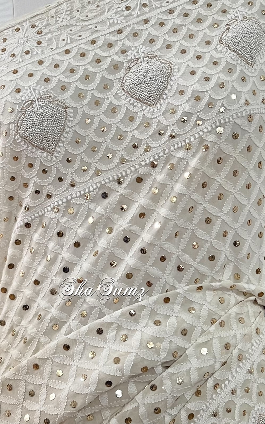Lily white saree featuring Chikankari, Mukaish work, and pearls close up