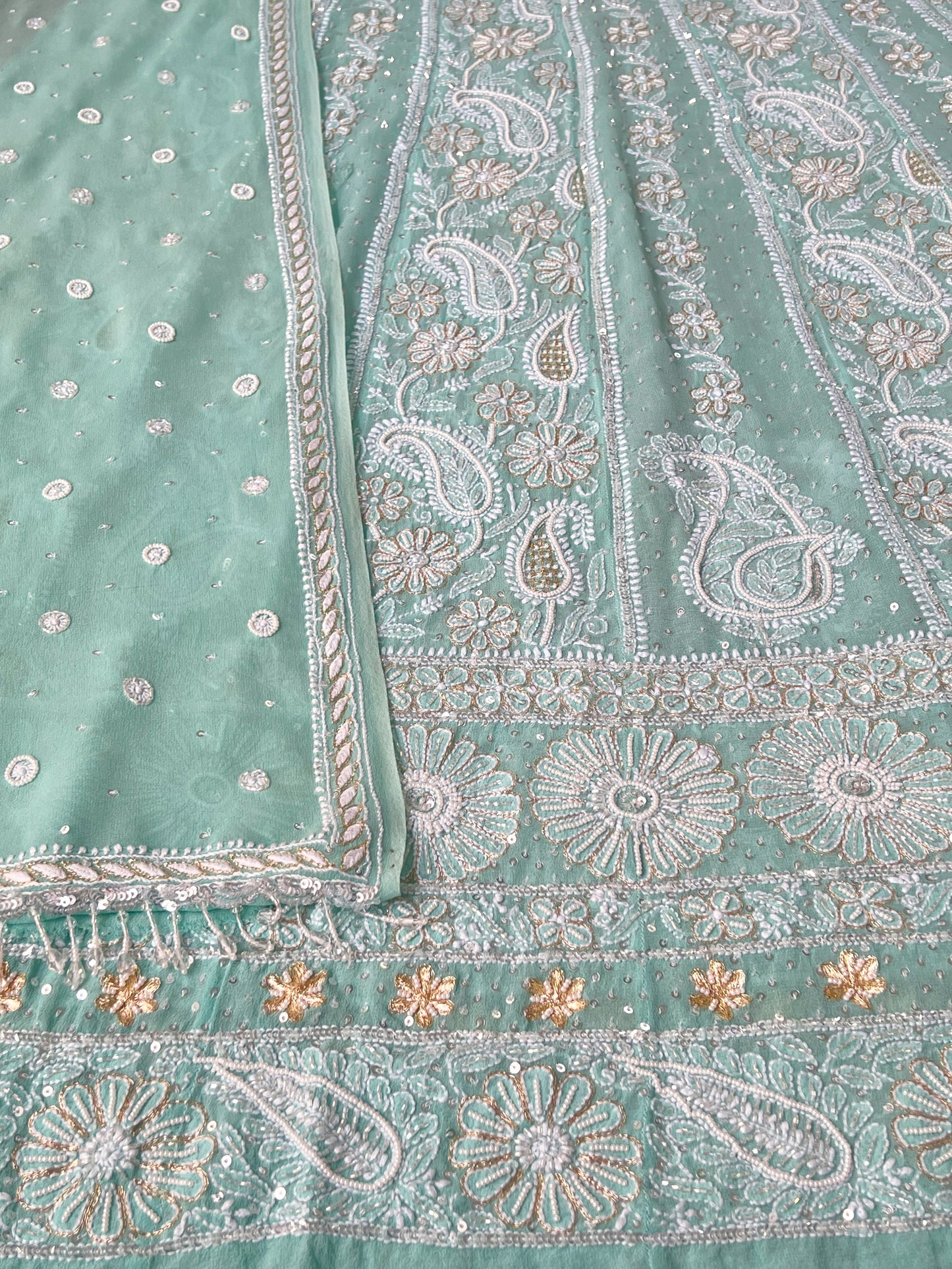 Close Up Mint green Anarkali featuring intricate Chikankari embroidery and embellishments on luxurious Pure Georgette fabric.