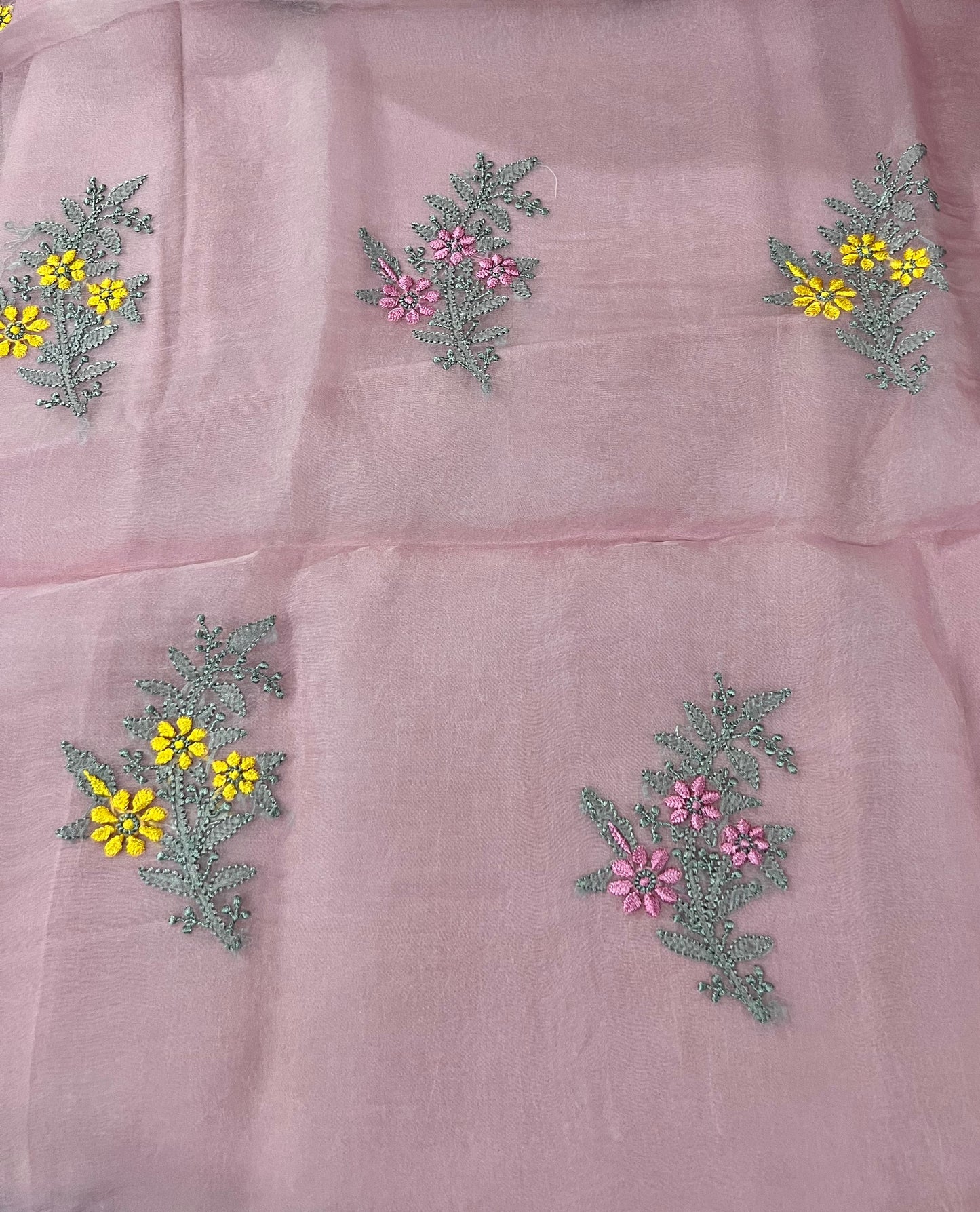 Pink Organza Silk Suit with Chikankari featuring floral embroidery in pink, grey, and yellow.
