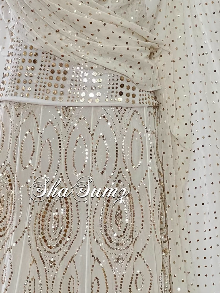 Close Up Elegant off white Mukaish lehanga with intricate embroidery and shimmering sequins on pure georgette fabric.