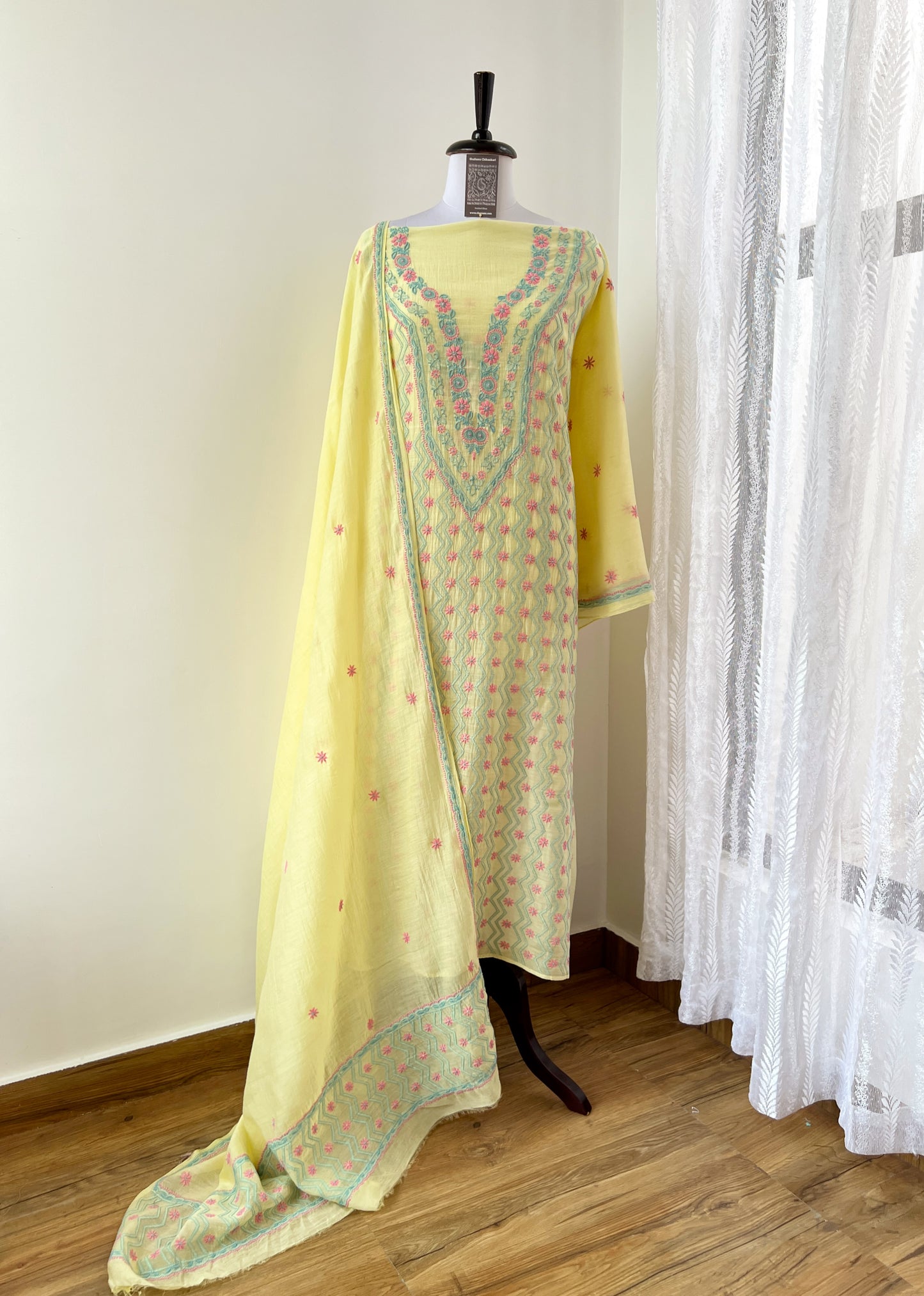 Lemon yellow Chikankari suit featuring intricate multicolour embroidery