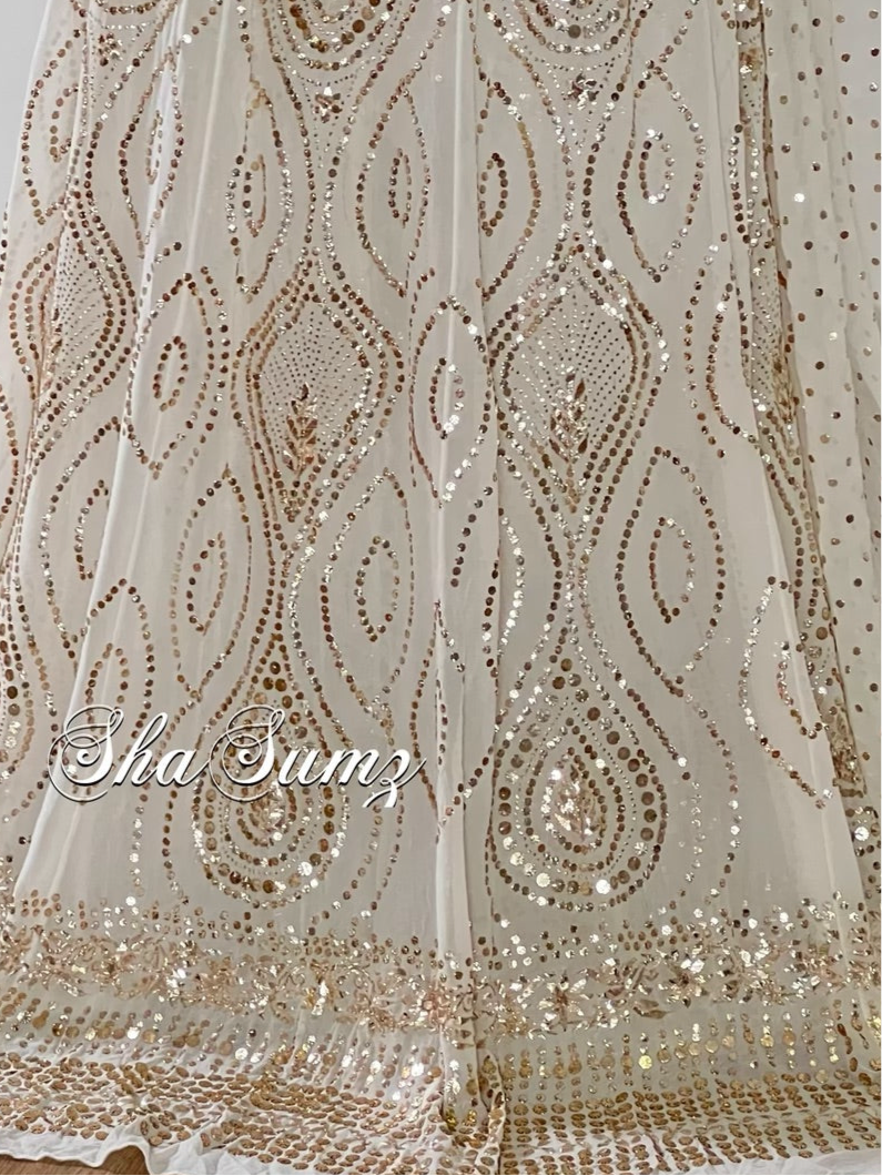 Off white lehenga with intricate Mukaish and Badla embroidery on pure georgette fabric, showcasing elegant sparkle.