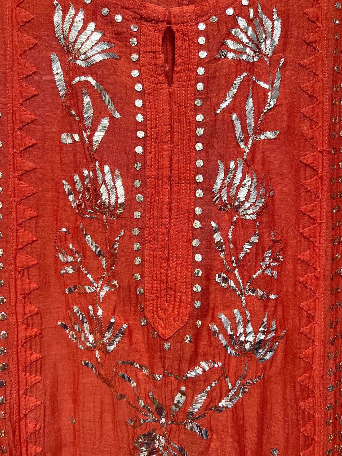 Rust Orange Mul Chanderi Suit with Mukaish hand-embroidered floral designs and silver embellishments.