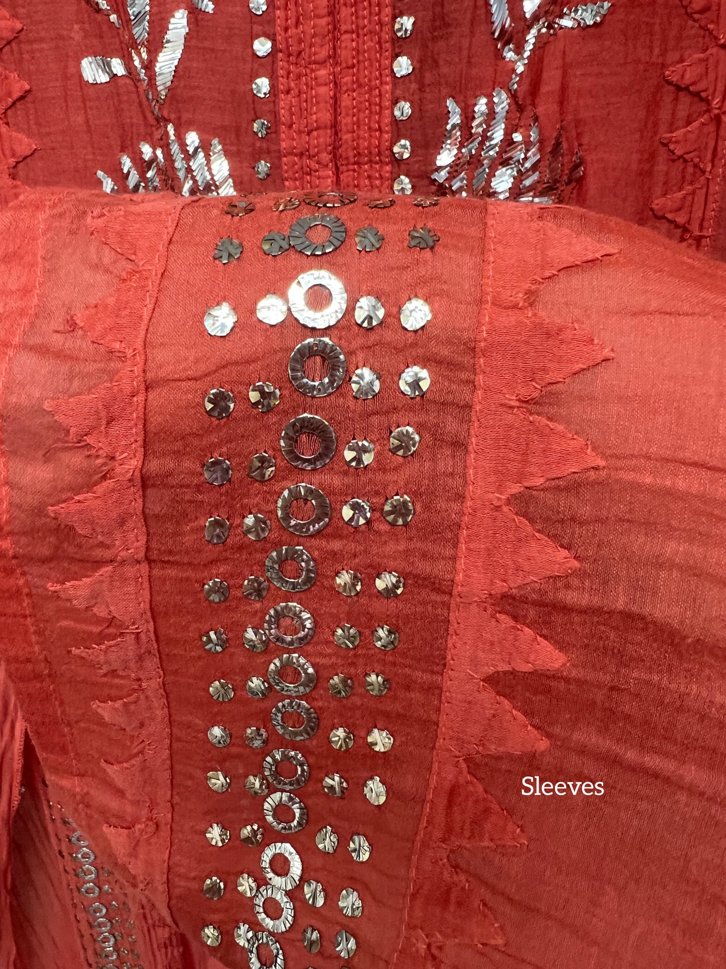 Rust Orange Mul Chanderi Suit with Mukaish detailed sleeves showcasing elegant embroidery and shimmer.