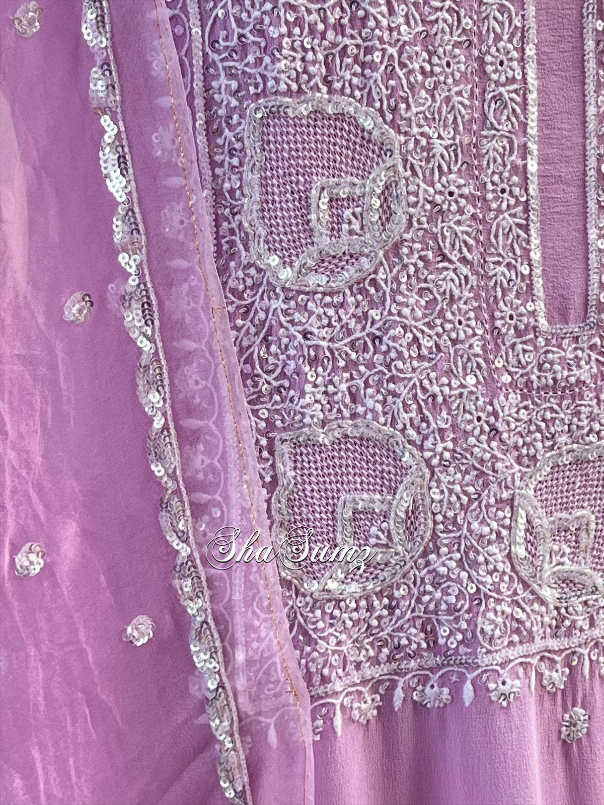 Close-up of a purple fabric with intricate chikankari