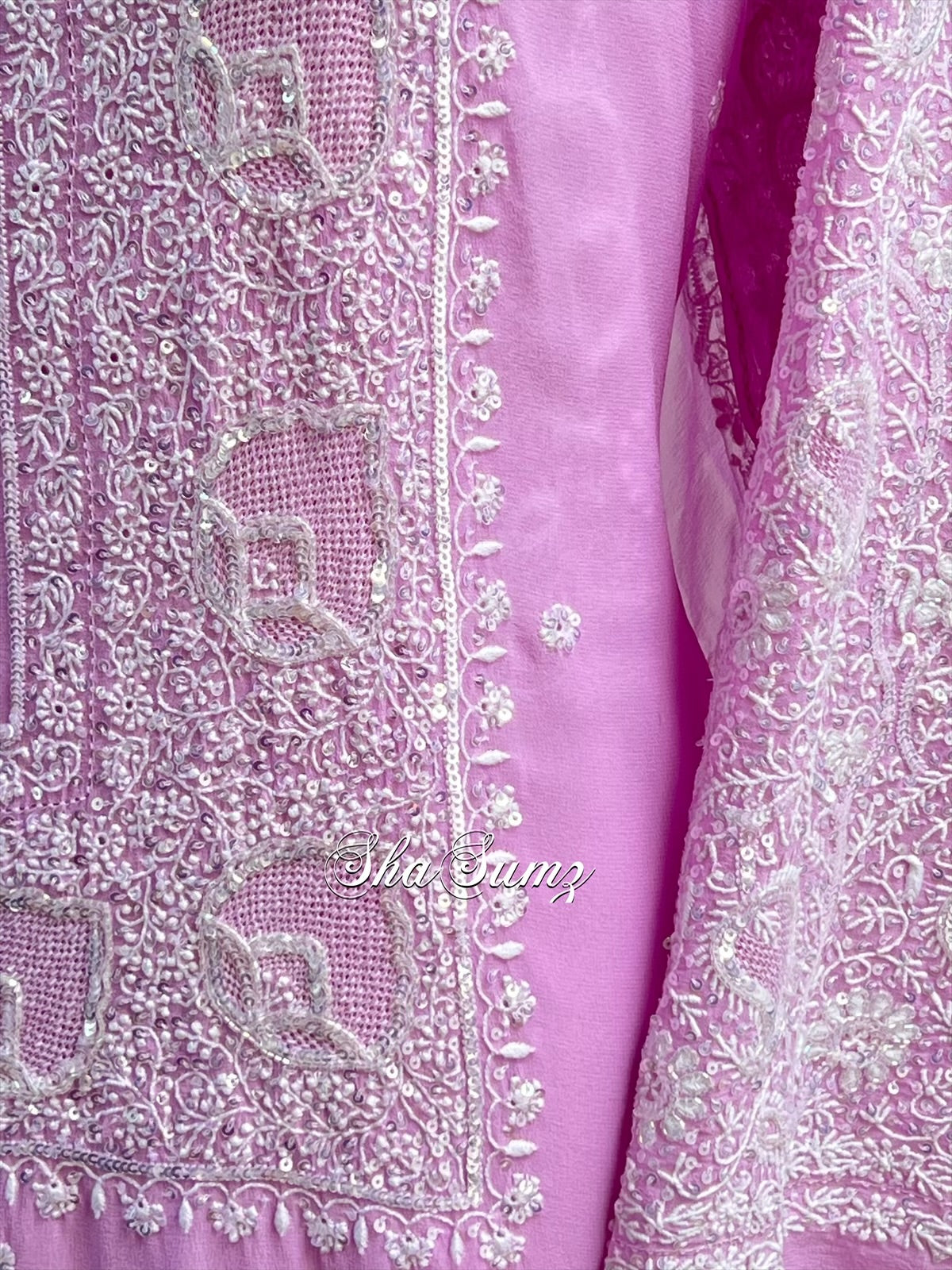 Close-up of a purple fabric with intricate embroidery
