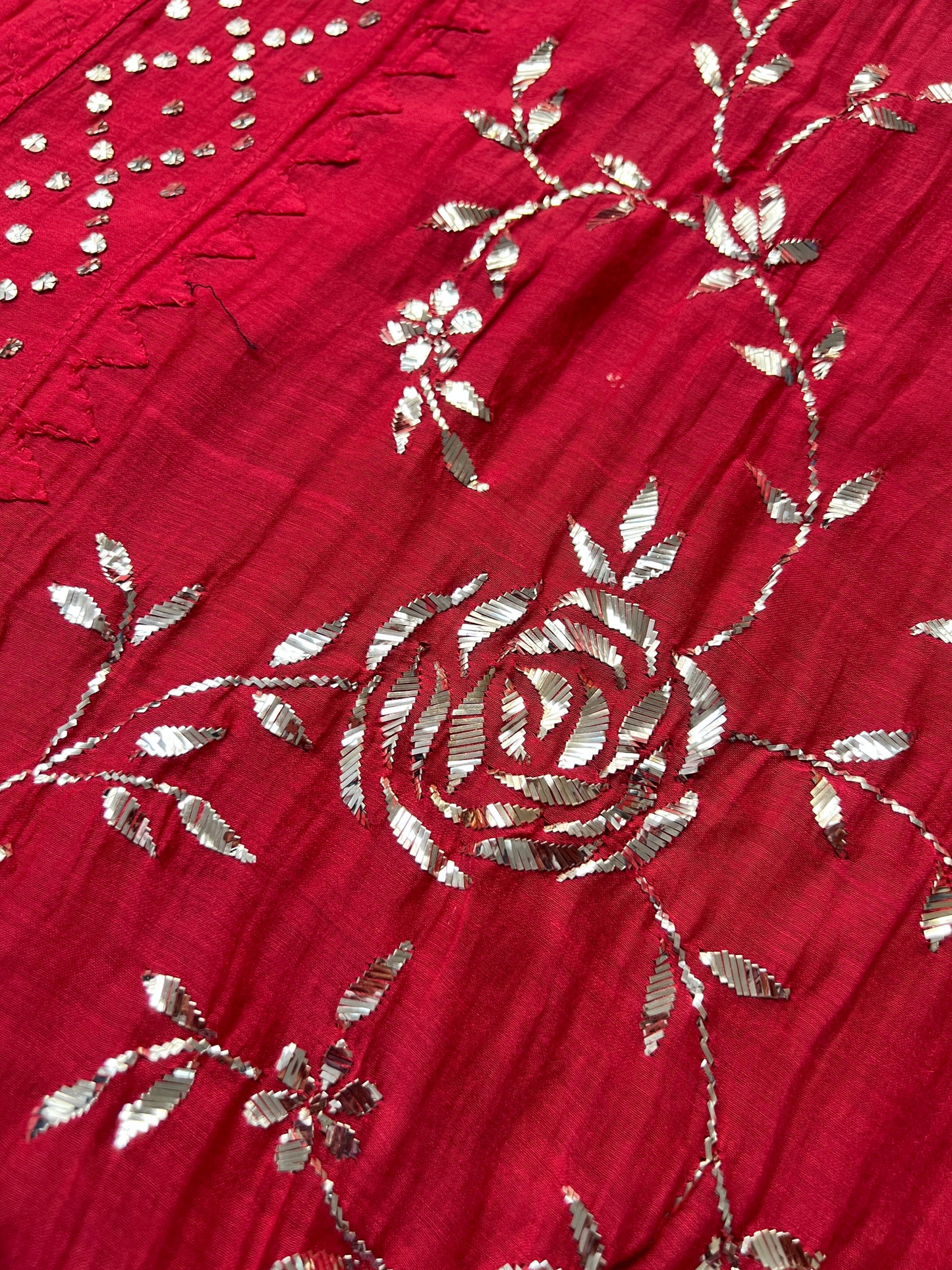 Close-up of Red Mul Chanderi Suit with Mukaish embroidery showcasing intricate silver floral patterns.