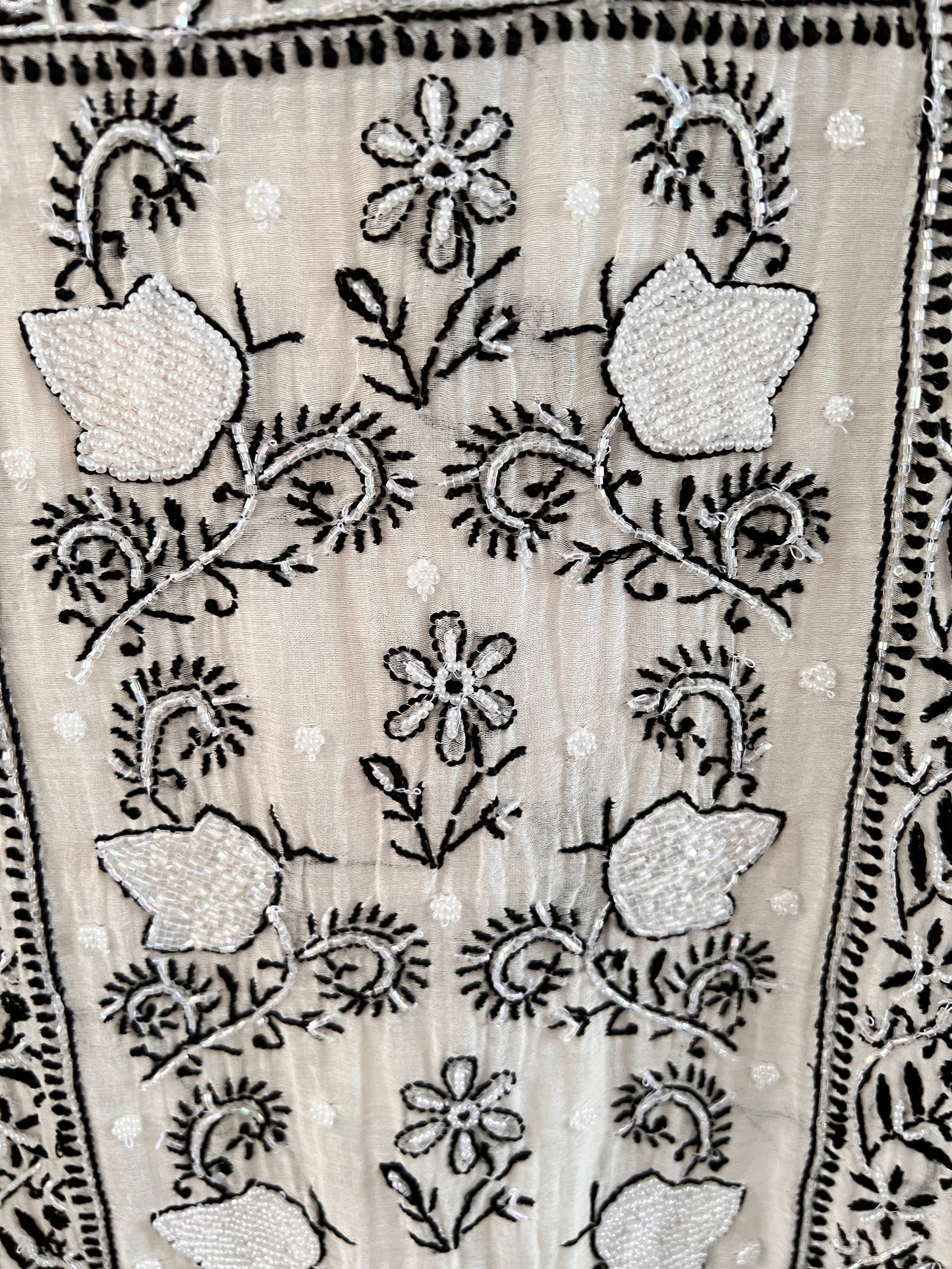 Monochrome Chikankari and Embellishments Kurta Set on Mul Chanderi with intricate detailing in natural light.