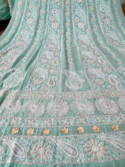 Mint green Anarkali featuring intricate Chikankari embroidery and embellishments on luxurious Georgette fabric.