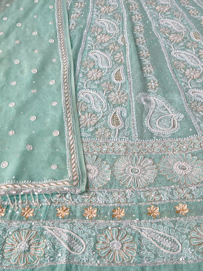 Close Up Mint green Anarkali featuring intricate Chikankari embroidery and embellishments on luxurious Pure Georgette fabric.