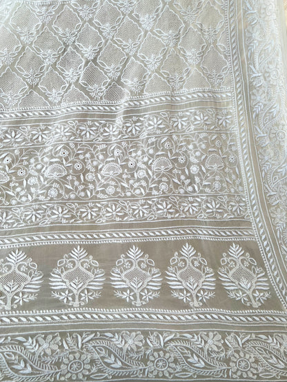 Intricate hand-embroidered Chikankari patterns on pearl white pure georgette fabric, showcasing elegant design.