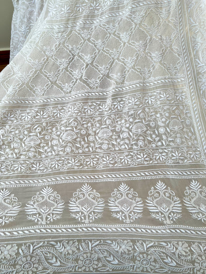 Intricate hand-embroidered Chikankari patterns on pearl white georgette fabric.