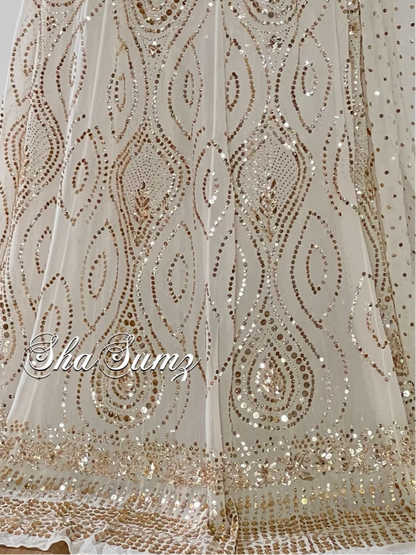 Off white lehenga with intricate Mukaish and Badla embroidery on pure georgette fabric, showcasing elegant sparkle.