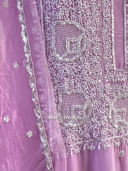 Close-up of a purple fabric with intricate chikankari