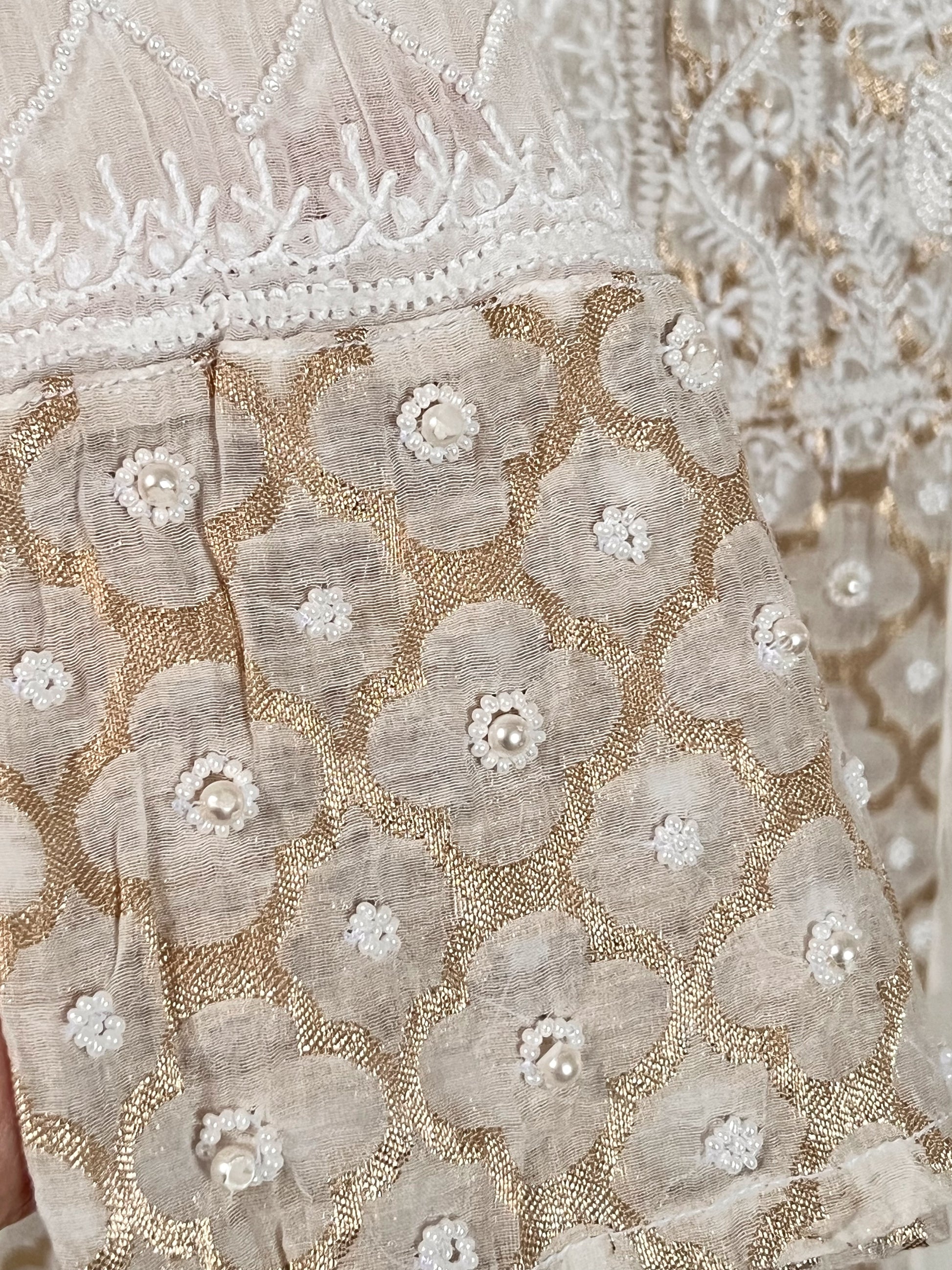 Detail of Mul Chanderi Chikankari kurta set showcasing intricate Zari weave and embellishments.