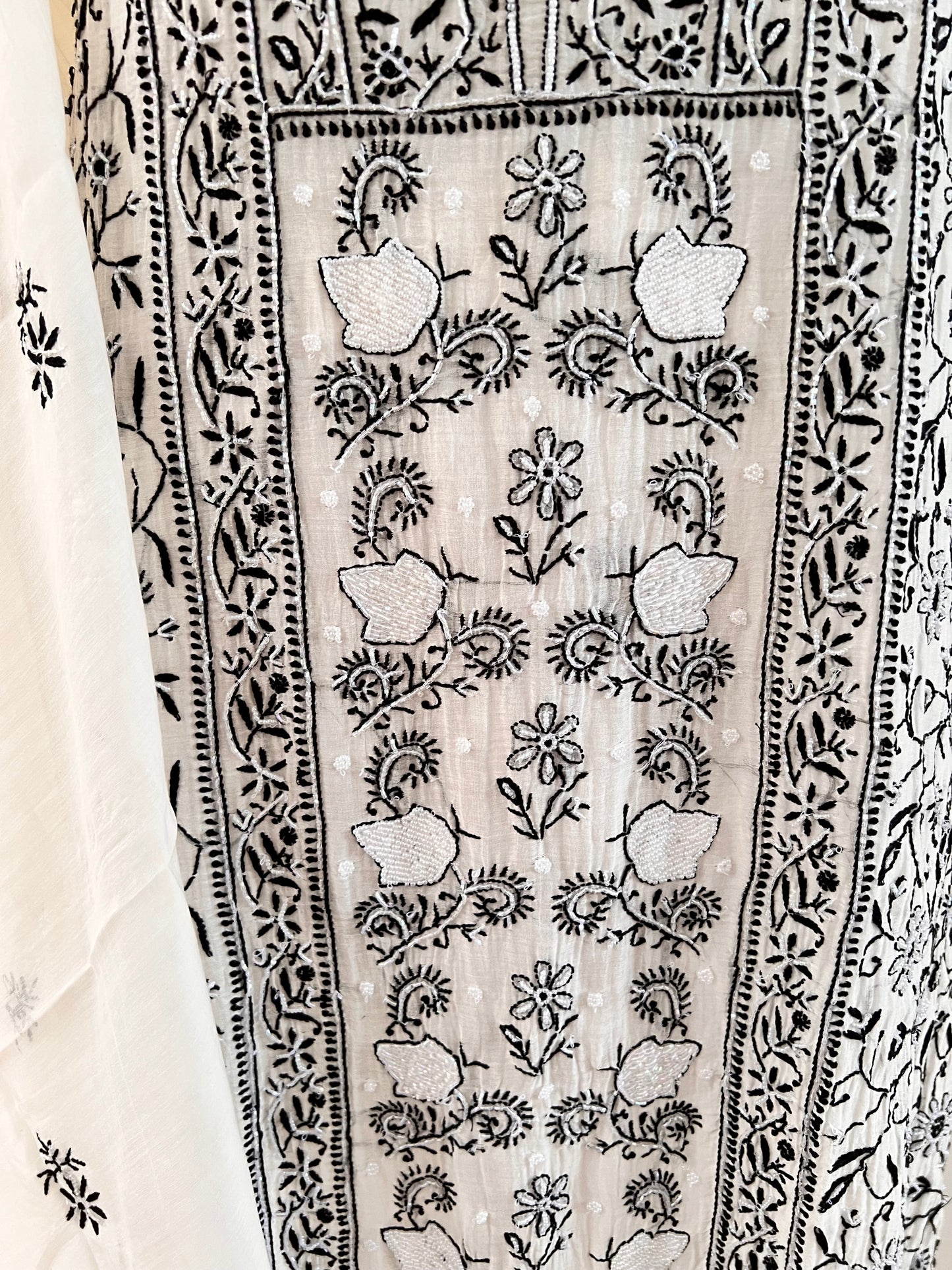 Monochrome Chikankari and Embellishments Kurta Set on Mul Chanderi with intricate detailing in natural light close up 