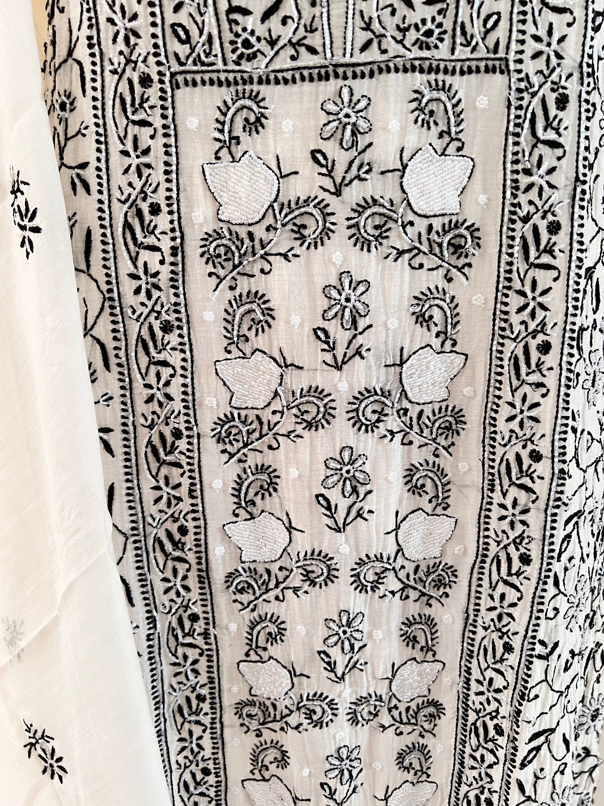 Monochrome Chikankari and Embellishments Kurta Set on Mul Chanderi with intricate detailing in natural light close up 