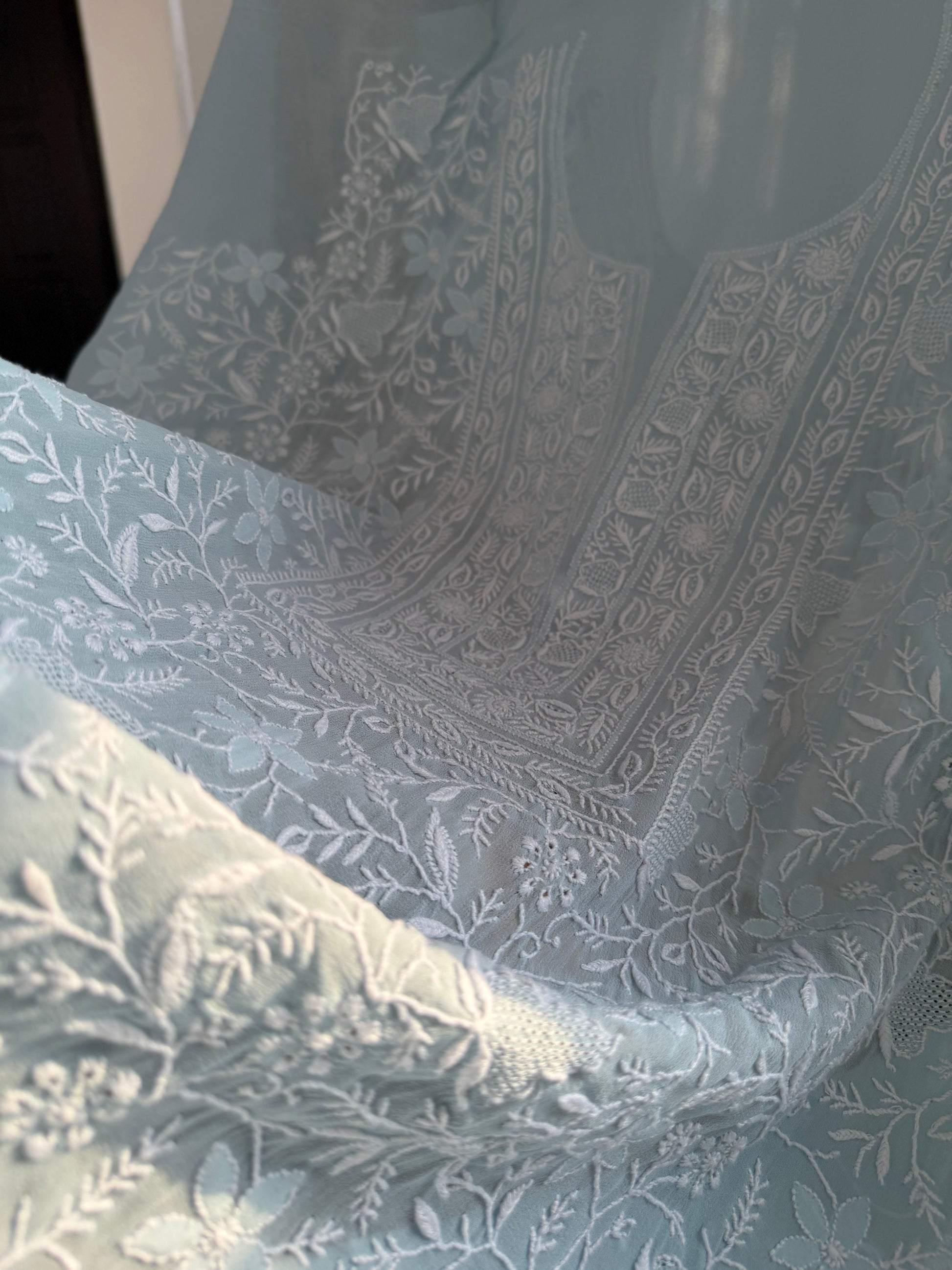 Intricate embroidery on the powder blue pure georgette suit with do Taar chikankari and Haath Jaali.