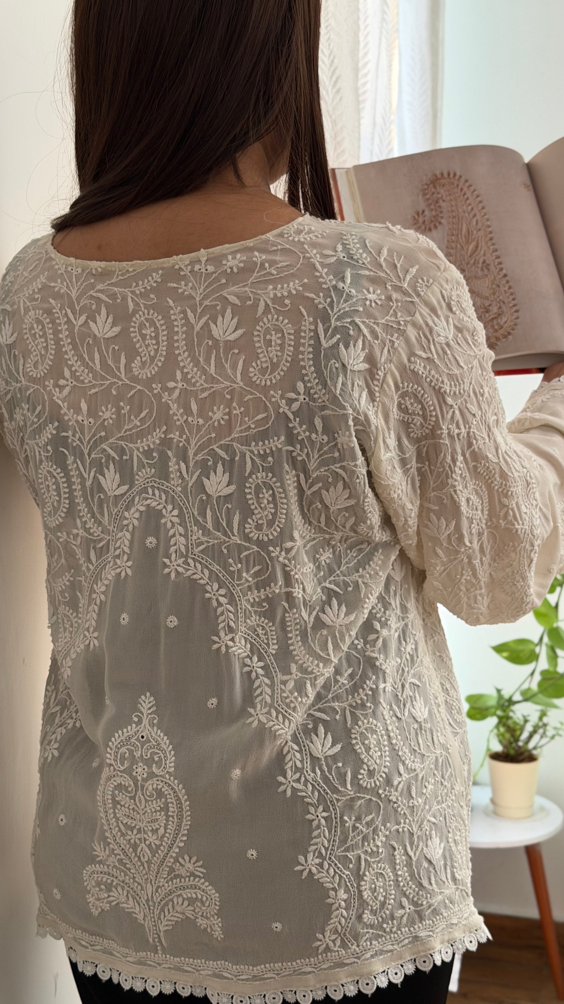 The Mehrab Shirt features hand-embroidered Chikankari on pure Georgette, showcasing intricate designs and elegant draping.