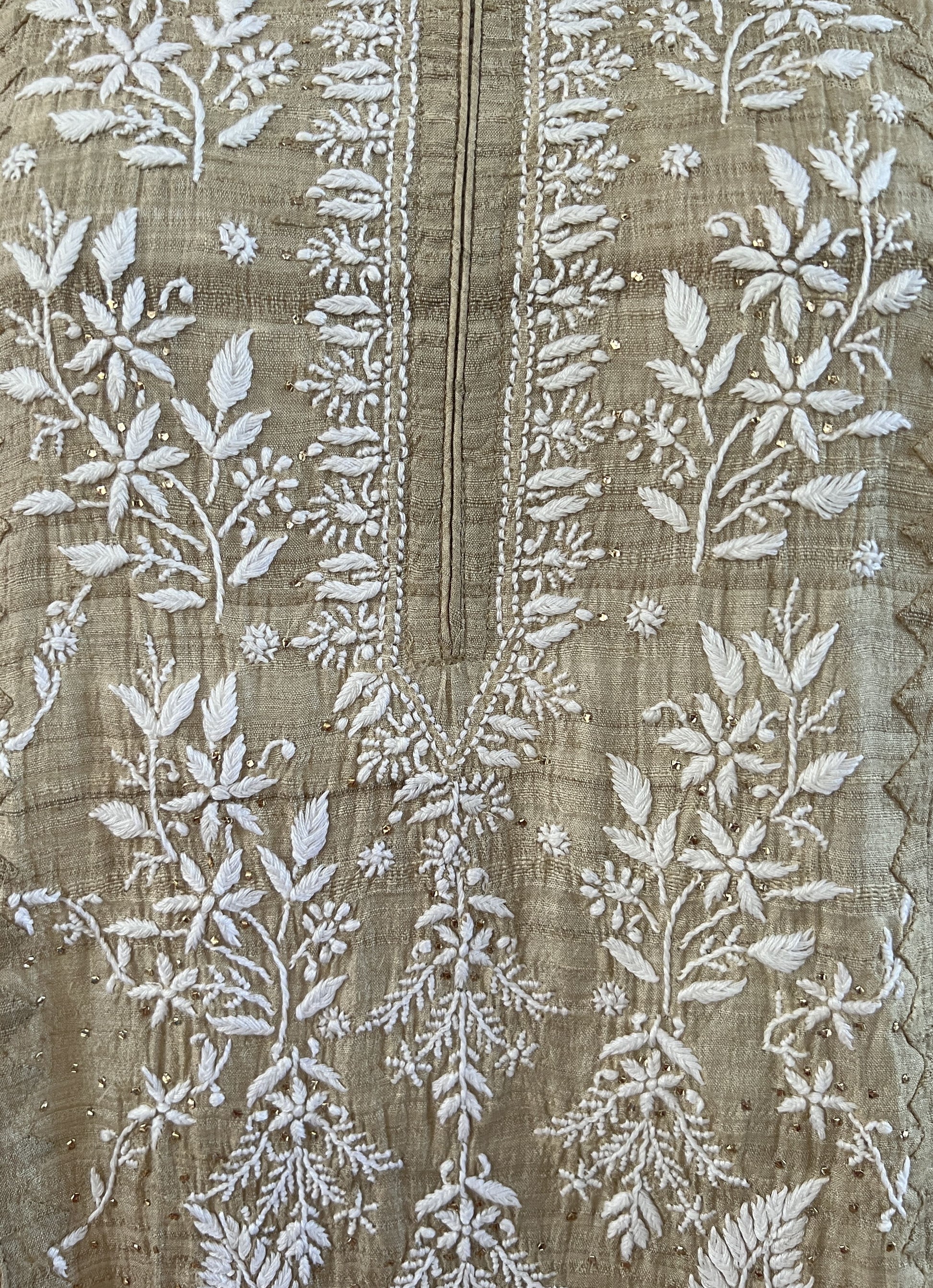Pure Tussar Silk kurta featuring intricate Chikankari and Mukaish embroidery on a textured background.