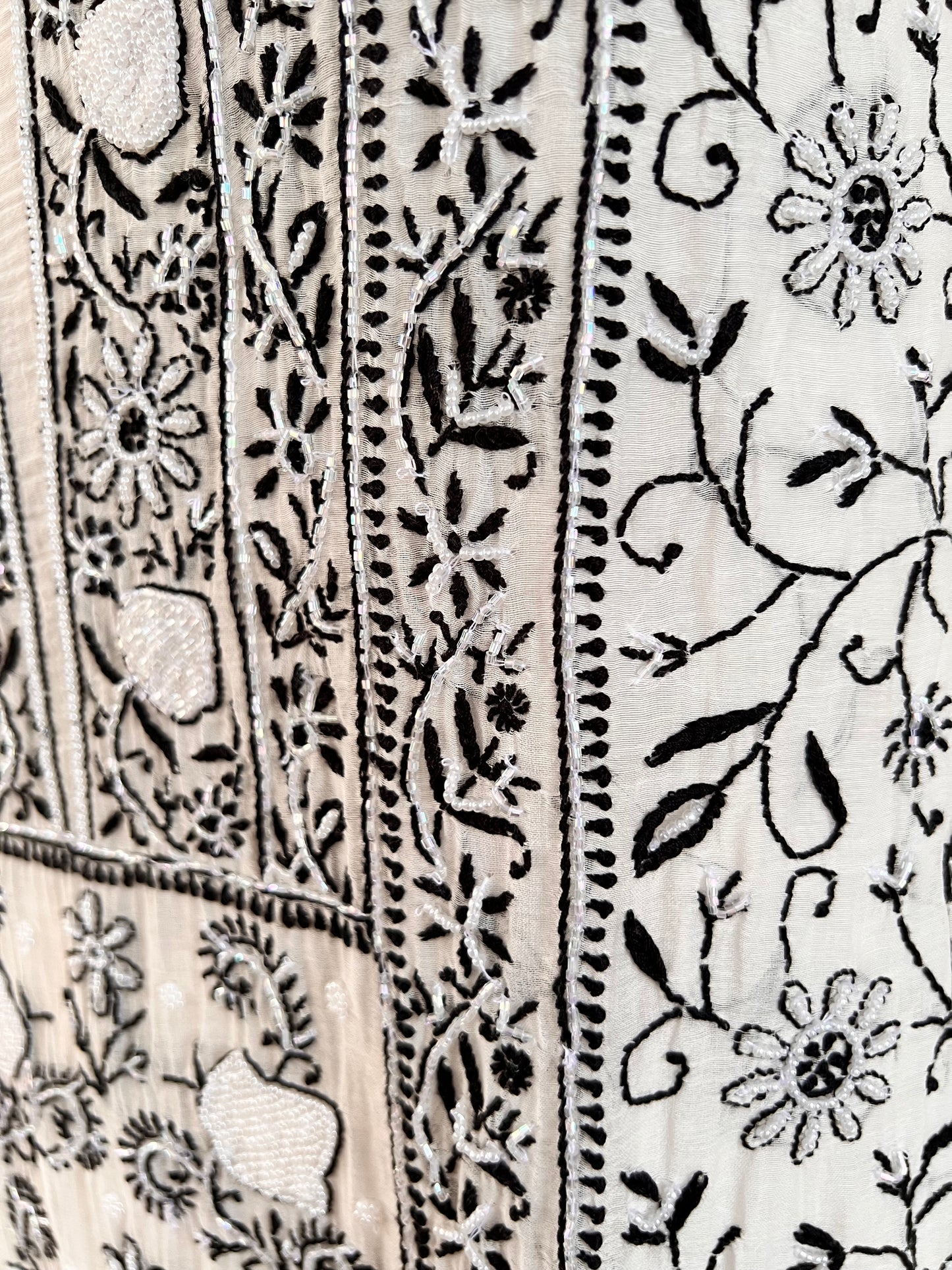 Monochrome Chikankari and Embellishments Kurta Set on Mul Chanderi with intricate detailing in natural light.