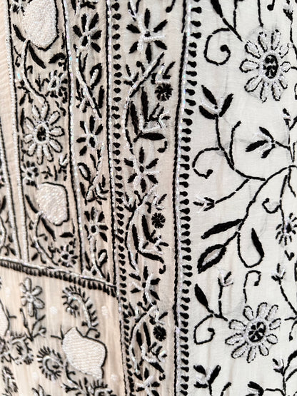 Monochrome Chikankari and Embellishments Kurta Set on Mul Chanderi with intricate detailing in natural light.